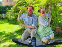 Die Klinikclowns auf der Schaukel im Garten